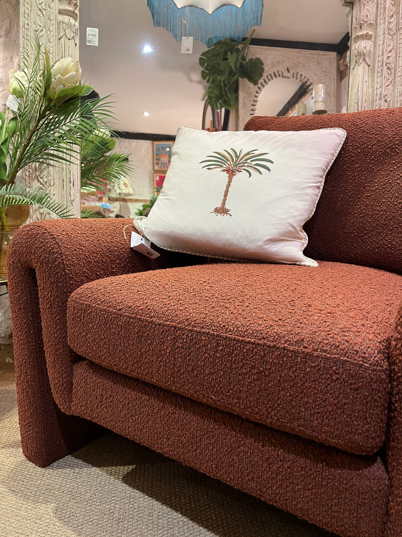 Burnt orange armchair in a soft boucle fabric