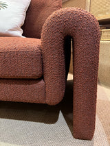 Burnt orange armchair in a soft boucle fabric